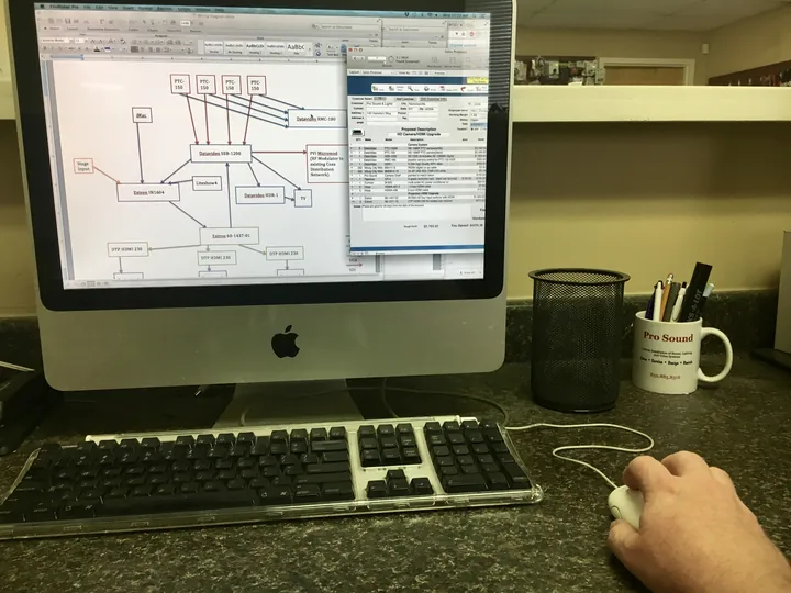 A Pro Sound & Lights designer reviewing system plans for a new install