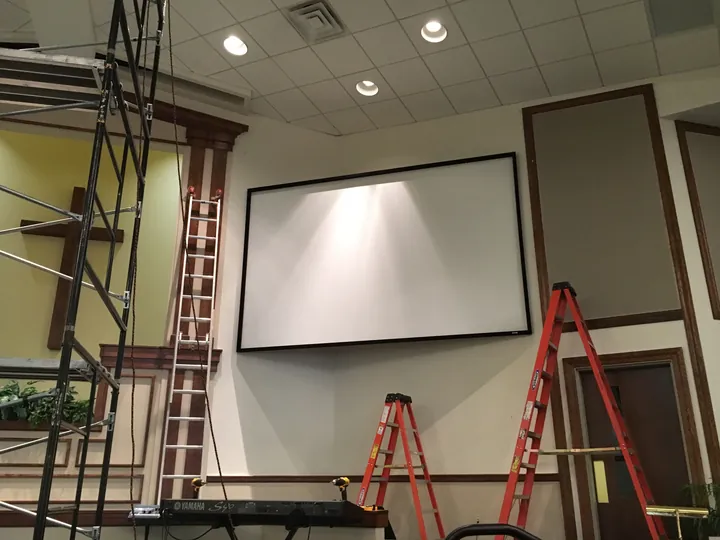 Technicians running cable during a sound system installation